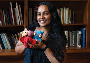 Julianne Somar ’26 shows off some of the nontraditional items in the emergency go-bag the team designed.