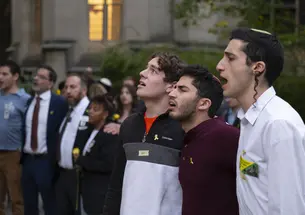 Mourners gather on the Frist Lawn North to sign and pray.