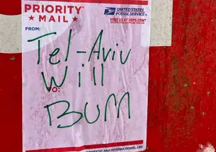 TelAvivBurnPoster.png A priority mail sticker from the United States Postal Service stuck to a stop sign. Handwriting in green marker on the sticker says "Tel-Aviv Will Burn"