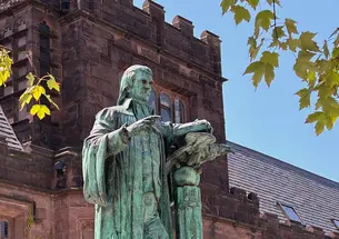 Statue of John Witherspoon with East Pyne Hall in the background