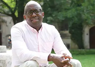 Jacob Dlamini sitting on steps on Princeton's campus.