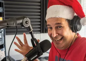 Jon Solomon in Santa Claus hat behind the mic int he WPRB studio