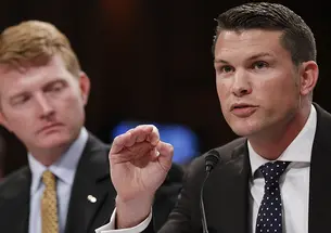 Pete Hegseth ’03, left, and another Army captain speak at a Senate Judiciary Committee hearing.
