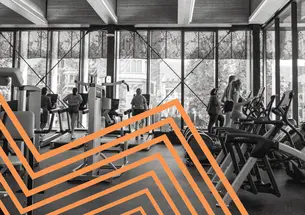 A black and white photo of people working out at a gym, with orange lines zigzagging over the left side.