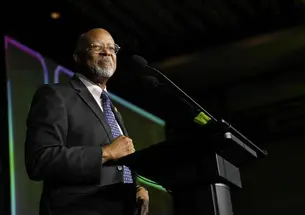 Rep. Glenn Ivey stand at a podium during election night. 