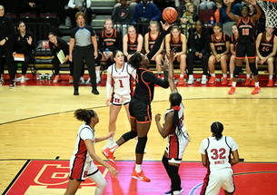 A Princeton basketball player launches the ball toward the basket from the paint.