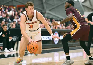 Caden Pierce ’26 drives to the basket against Iona Nov. 4, when he scored 18 points in Princeton’s comeback win.