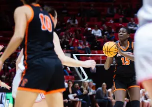 Fadima Tall ’27, a basketball player in a black Princeton uniform, sets up a shot.