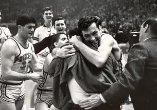 Bill Bradley ’65 embraces coach Butch van Breda Kolff ’45 after Princeton beat Providence to advance to the 1965 Final Four, the program’s only appearance in the men’s basketball national semifinals.