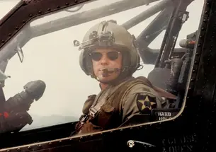 Christopher Hornbarger in military flight uniform piloting a helicopter
