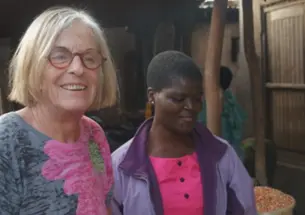 Susan Cotts Watkins *80, left, in Malawi with young Malawian girl.