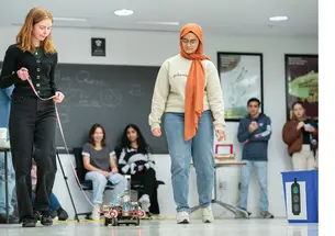 Caroline Rasmussen ’26, left, and Yushra Guffer ’26 present their Car Lab vehicle at the end of the semester, a tradition that began in the 1990s