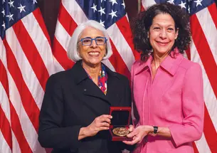Professor Bonnie Bassler, right, receives the National Medal of Science from White House adviser Arati Prabhakar.