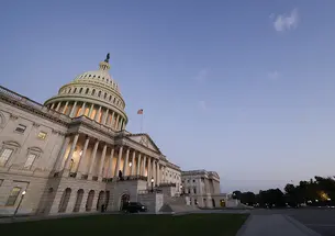 The U.S. Capitol, photographed from an angle at dusk.