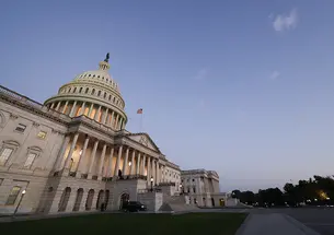 The U.S. Capitol, photographed from an angle at dusk.