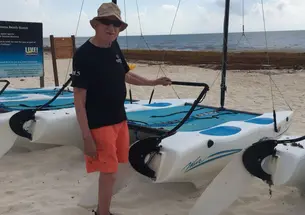 Donald Fletcher ’39 *51 stands in front of boats on a beach in Mexico.