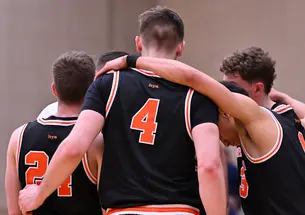 Princeton men’s basketball in a huddle.