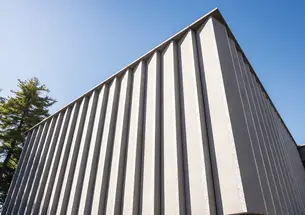 A corner of the striped, concrete outside of the new art museum.