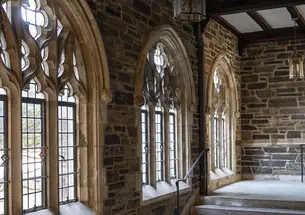 Gothic stone windows above a staircase in the Graduate College.