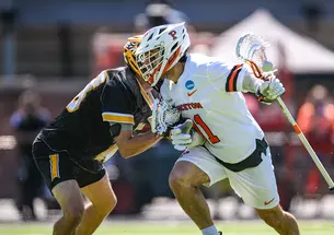 Coulter Mackesy cradles the ball in his stick as he tries to get past a defender