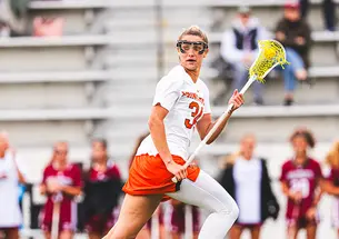 Lacrosse attacker McKenzie Blake runs while cradling the ball in her stick