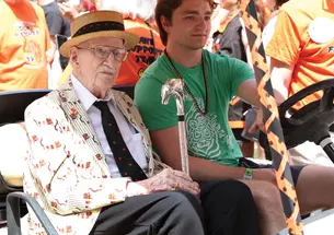 Donald Fletcher ’39 *51 riding in a gold cart during the 2024 P-rade