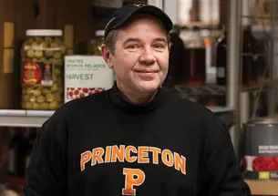 Damon Schunk, a senior storekeeper in Campus Dining, standing in a large food pantry