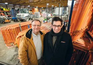 Devin Livi, director of campus grounds, left, and Robert Staudt, assistant director of campus grounds stand in the the storage area for much of the Reunions hardware such as fending, electrial wires, etc.