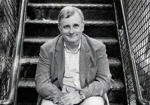 EdmundWhite2004_cropped.jpg Edmund White sits on a fire escape in this black-and-white photo.