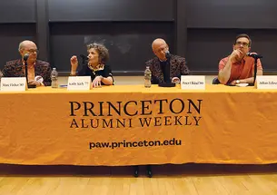 Four people sit behind a table covered with an orange tablecloth that reads "Princeton Alumni Weekly: paw.princeton.edu."