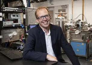 Andrew Houck seated in an engineering laboratory