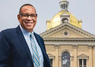Dale Caldwell ’82 in front of a building with a gold dome at Centenary University.