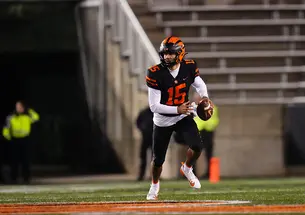 Quarterback Blaine Hipa runs to his left and looks downfield