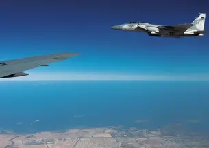 An F-15QA, right, flies in formation with a U.S. plane during exercises over Qatar in January. 