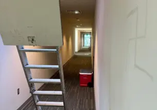 Remnants of graffiti on the wall of a hallway in the Lawrence Apartments