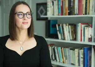 Julia Iofee stands in her library