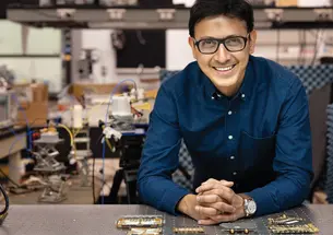 Kaushik Sengupta in what looks like an electrical engineering lab.
