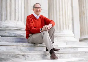 President Eisgruber sits on the steps on Whig Hall