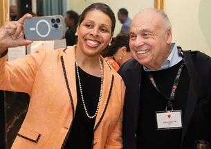 MANY MINDS_Julius Coles.jpg Karen Jackson-Weaver ’94 takes a selfie with Julius Coles *66 during a reception at Prospect House.