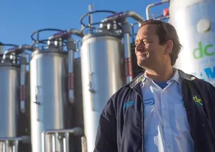 George Hawkins ’83 founded Moonshot Missions is pictured here in front of a thermal hydrolysis reactor and flash tank which converts wastewater biosolids into usable energy