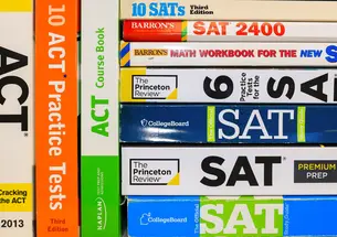Stack of colorful SAT and ACT test prep books