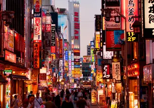 View of city street in Tokyo, Japan filled with signs and advertisements.
