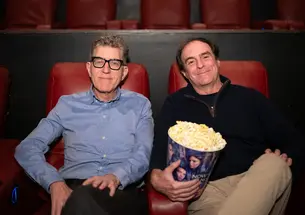 Mitchell Duneier and Mark Bernstein at the AMC Marketfair 10 movie theater sitting in their seats with popcorn waiting to watch the new Springsteen movie