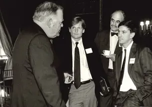 Michael Lewis ’82, second from left, and Starling Lawrence ’65, second from right, in discussion with Rev. Timothy S. Healy in the 1980s.