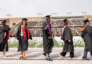 Students walk to their seats during the 2025 Commencement