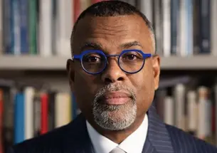 Eddie Glaude Jr. *97 photographed in front of a bookshelf 