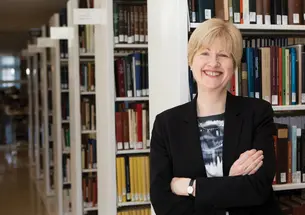 University Librarian Anne Jarvis poses in the stacks at Firestone Library