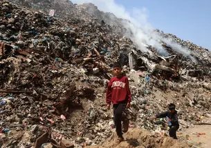 Children search for items to salvage at a waste dump in Gaza City, Palestinian Territories, on April 19, 2026.