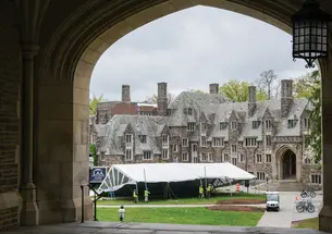 Crews setting up a tent on campus