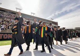 students walk into the Commencement ceremony